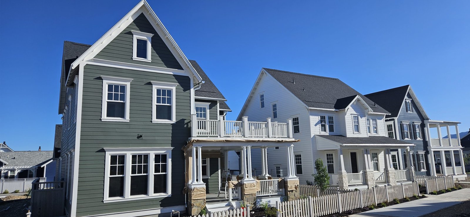 Exterior home design inspiration showcasing green and white color palette.