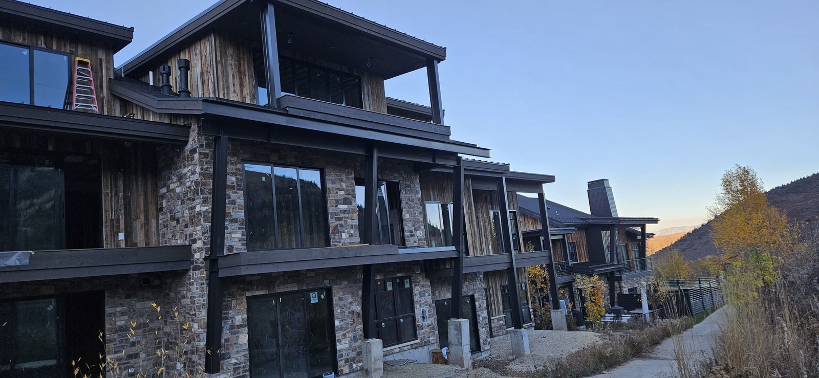 A house in Utah with a newly painted deck and balcony, showcasing a rustic wood finish