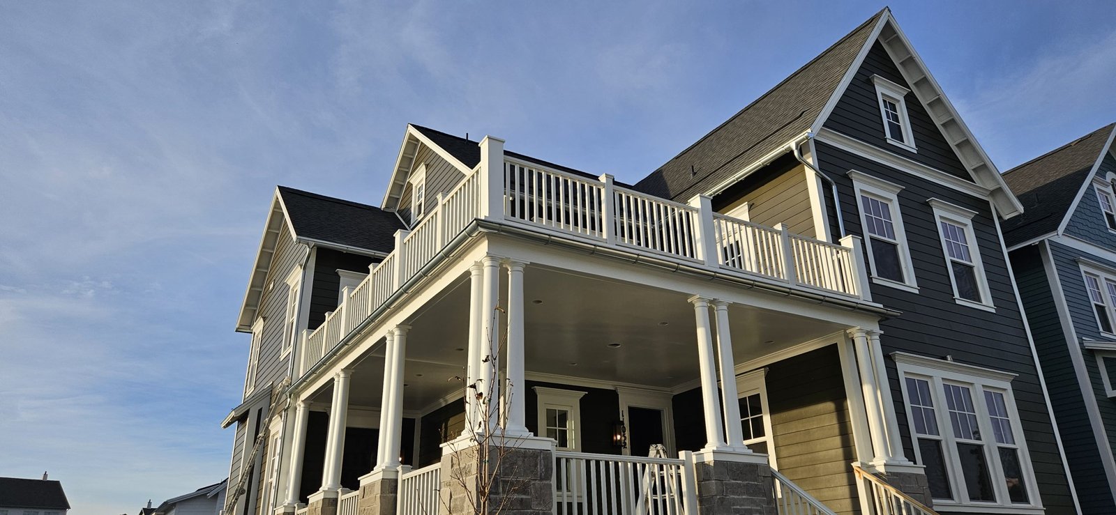 Utah home with balcony featuring white columns and railings, ideal for painting and restoration.