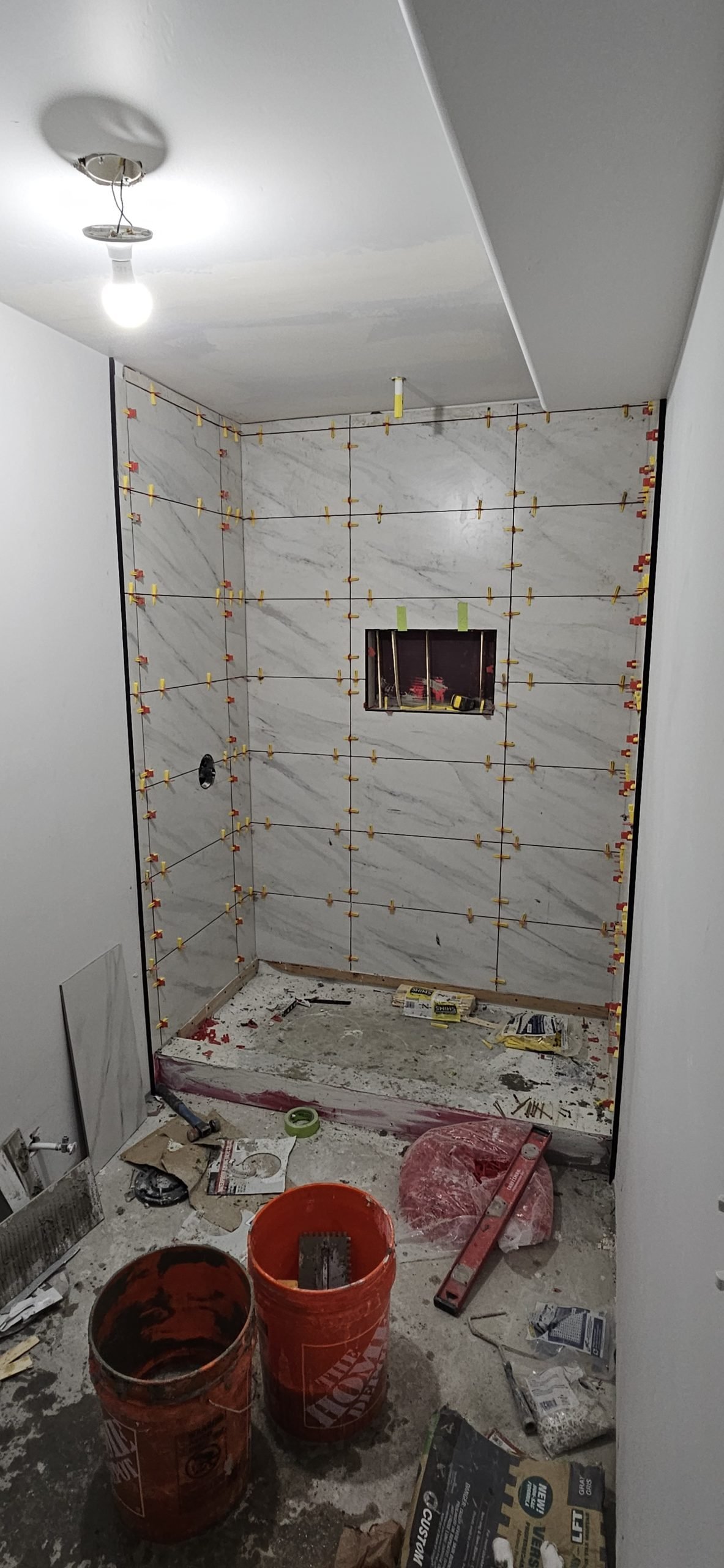 Bathroom remodeling in Utah featuring gray tile installation on shower walls.