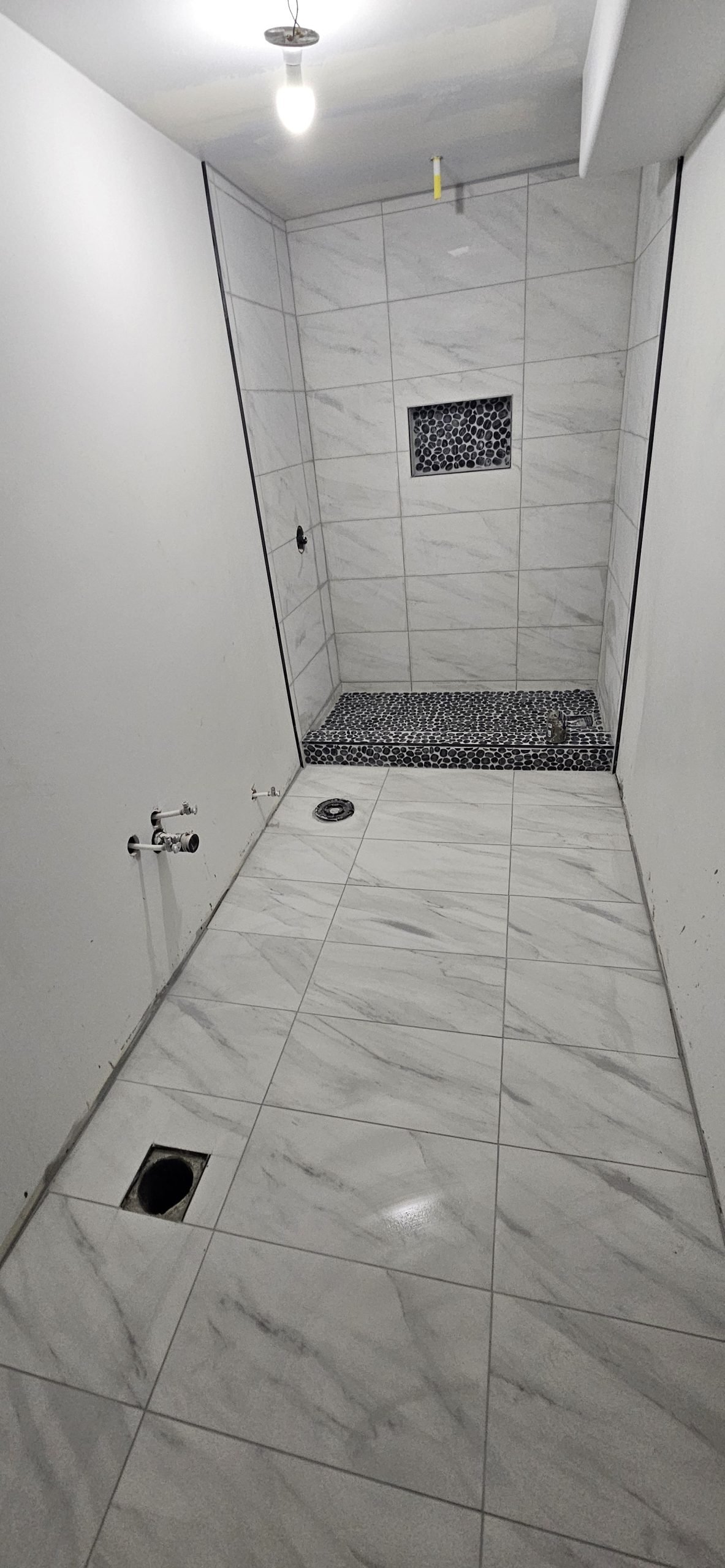 Bathroom renovation in Utah featuring marble tile shower and floor.