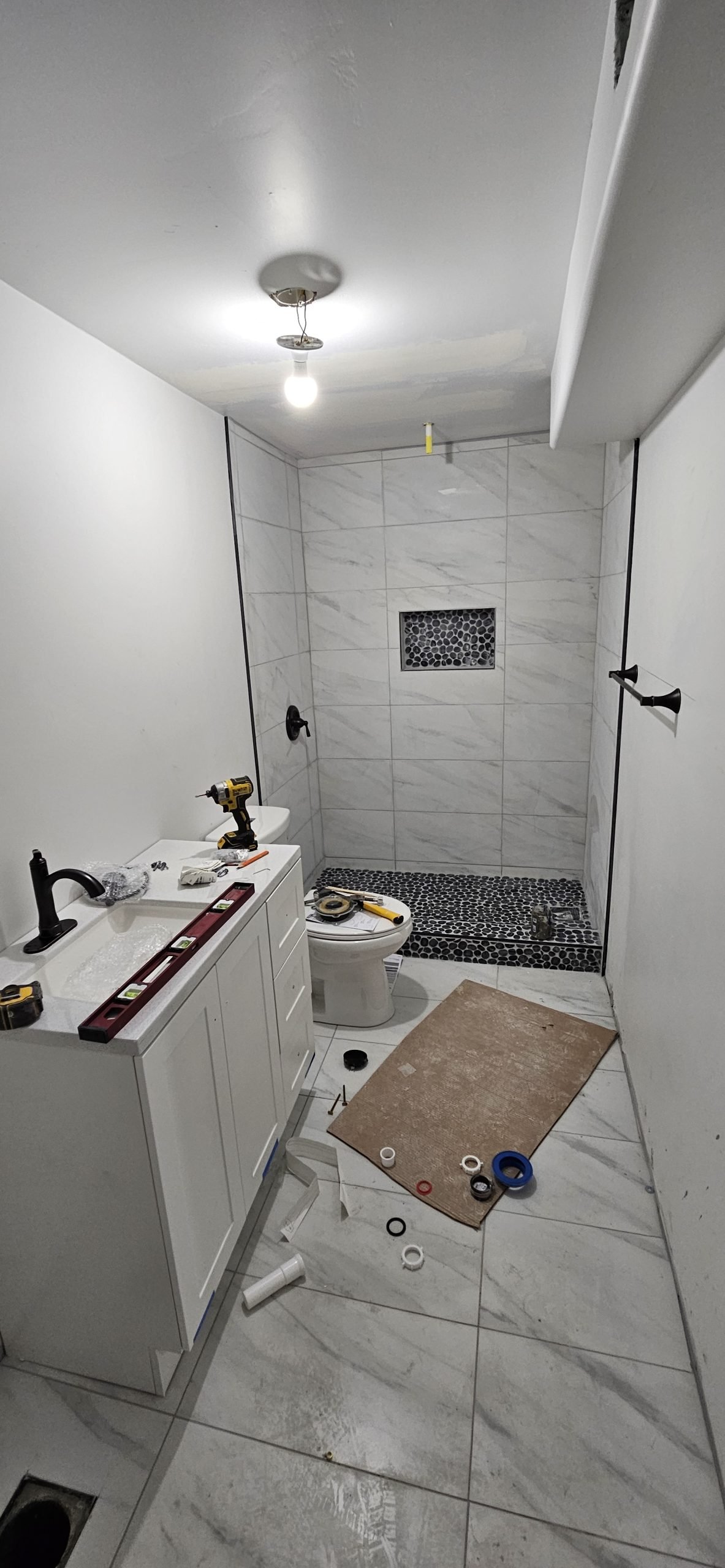 Bathroom renovation in Utah featuring marble tile shower and floor.