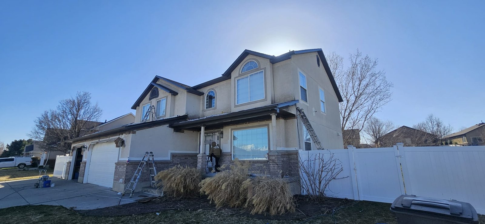 Utah home with gray siding, white trim, and black shutters.