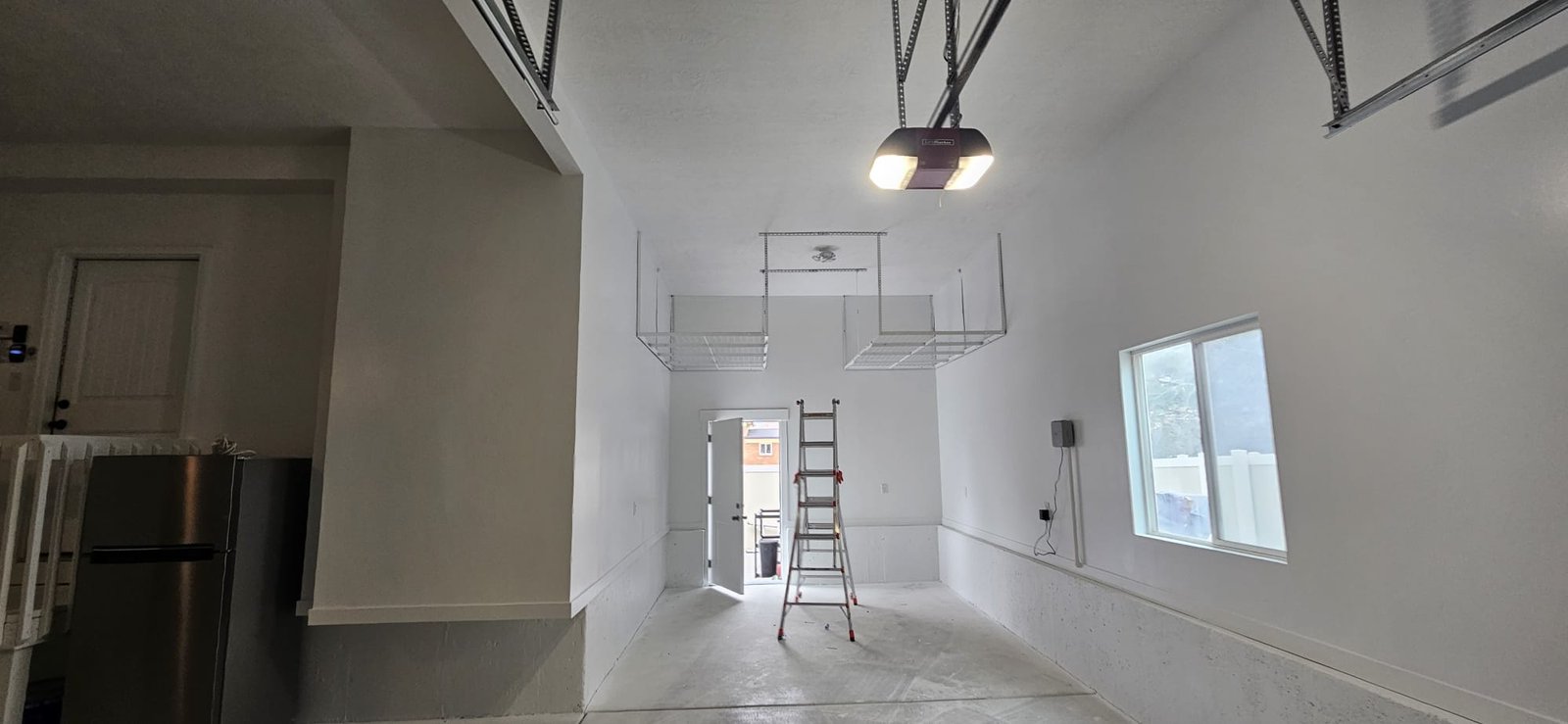 Painted, Clean and organized garage with white walls and ceiling.