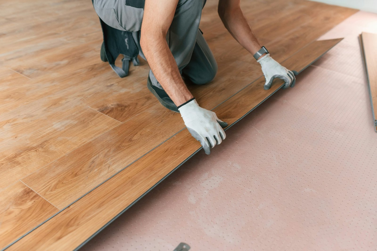 Hand work. Man is installing new laminated wooden floor