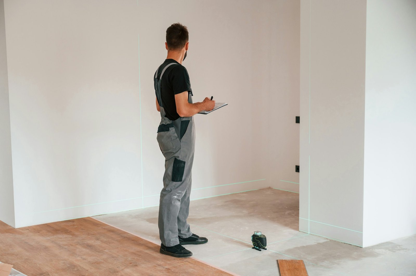 Man is installing new laminated wooden floor